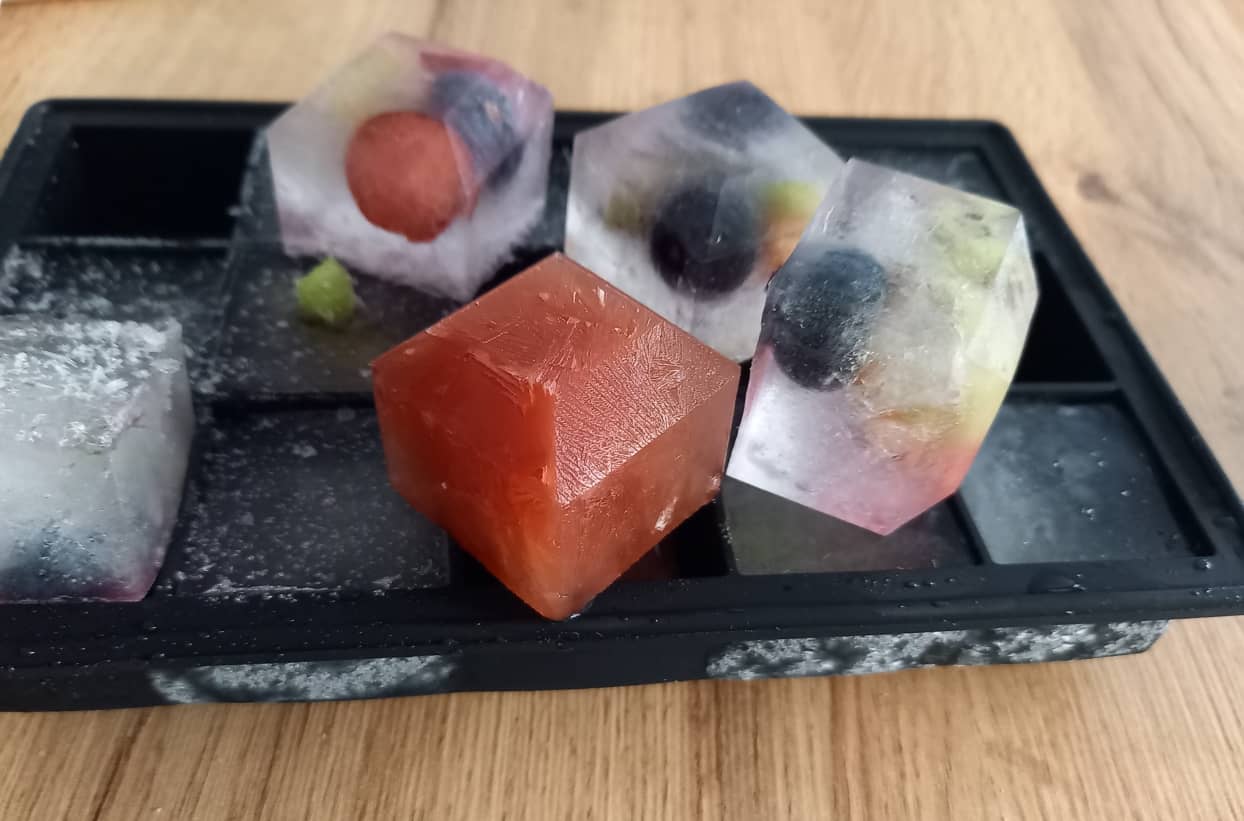 Eiswürfel mit Früchten auf einem Tablett